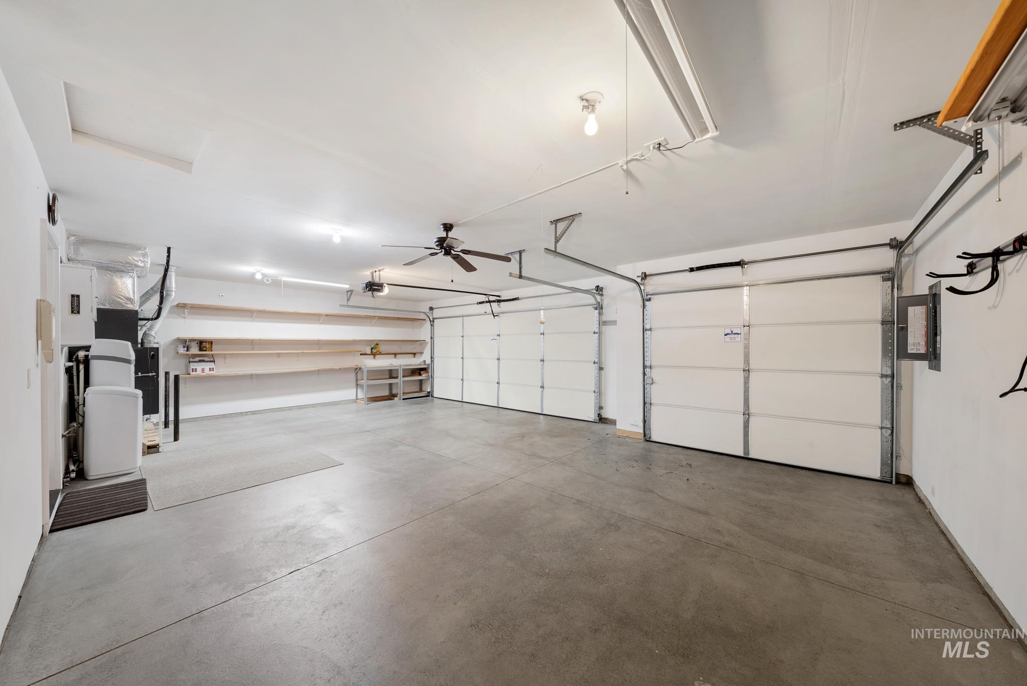 19081 Harley Way Caldwell, ID 83605 - Photo 30 of 35 Garage featuring a ceiling fan, heating unit, and electric panel