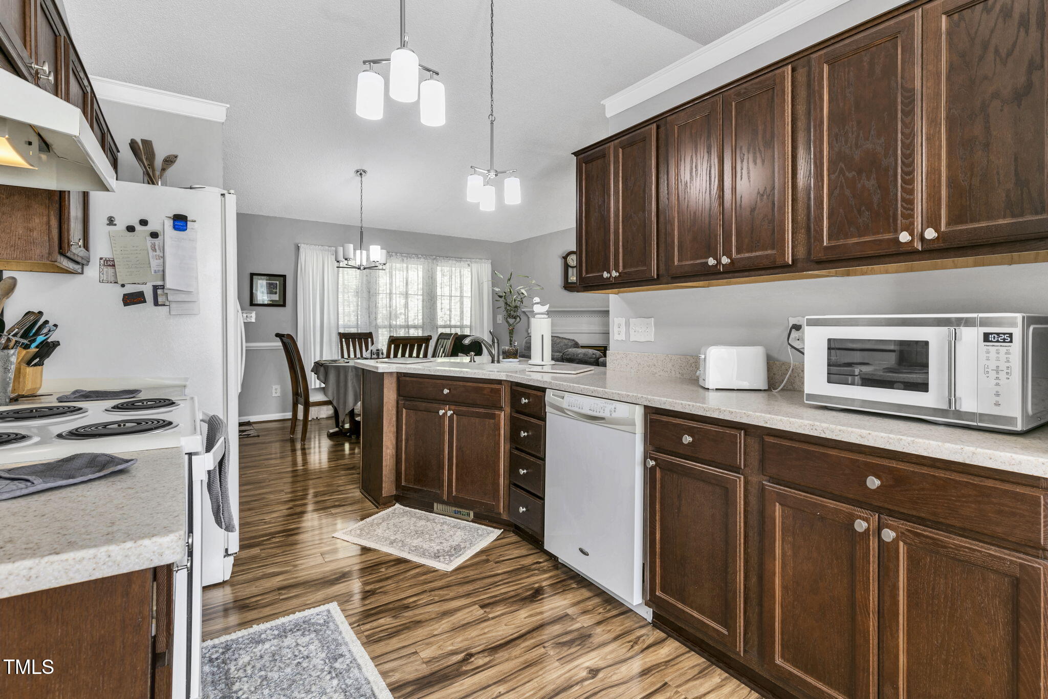 4317 Snow Goose Court Raleigh, NC 27616 - Photo 10 of 43 a kitchen with stainless steel appliances granite countertop wooden cabinets a stove top oven a sink and dishwasher