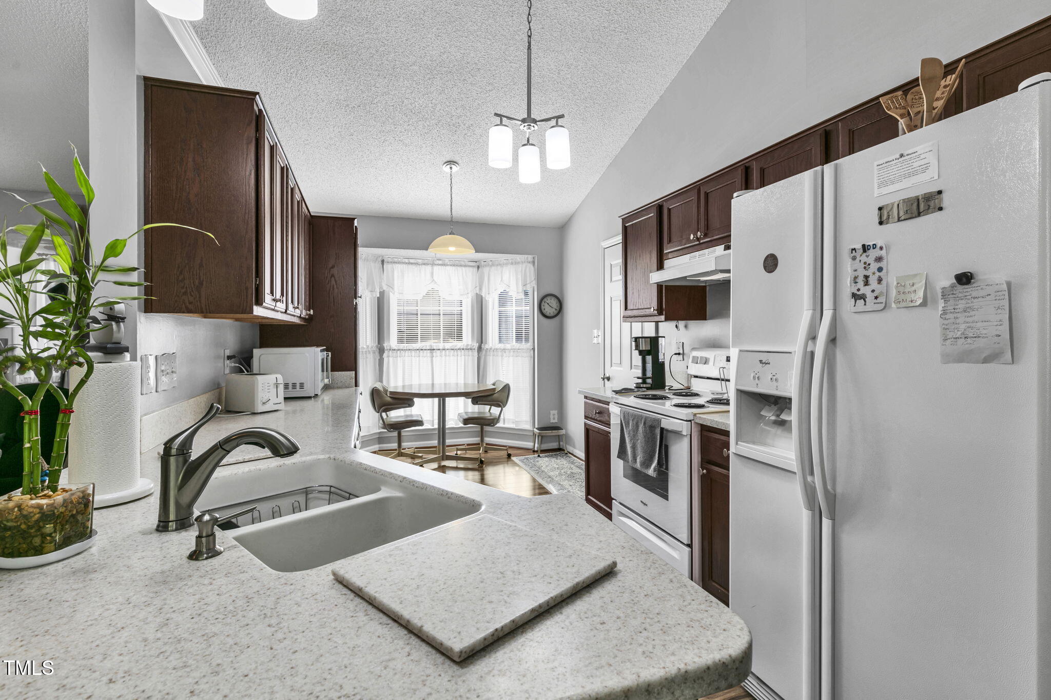 4317 Snow Goose Court Raleigh, NC 27616 - Photo 11 of 43 a kitchen with stainless steel appliances granite countertop a sink a stove and a refrigerator