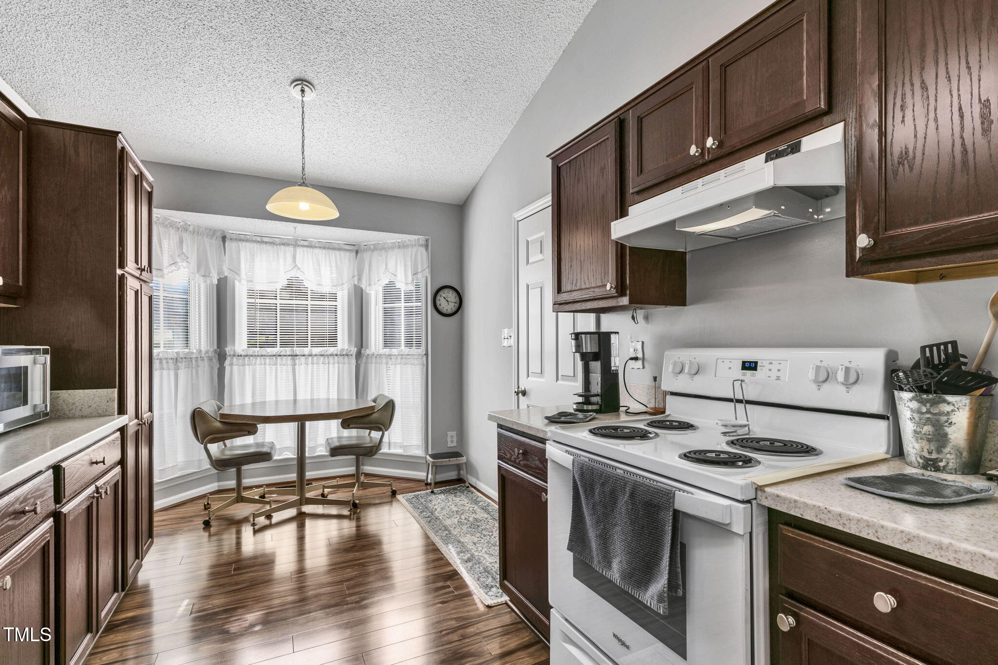 4317 Snow Goose Court Raleigh, NC 27616 - Photo 13 of 43 a kitchen with a stove a refrigerator and wooden cabinets