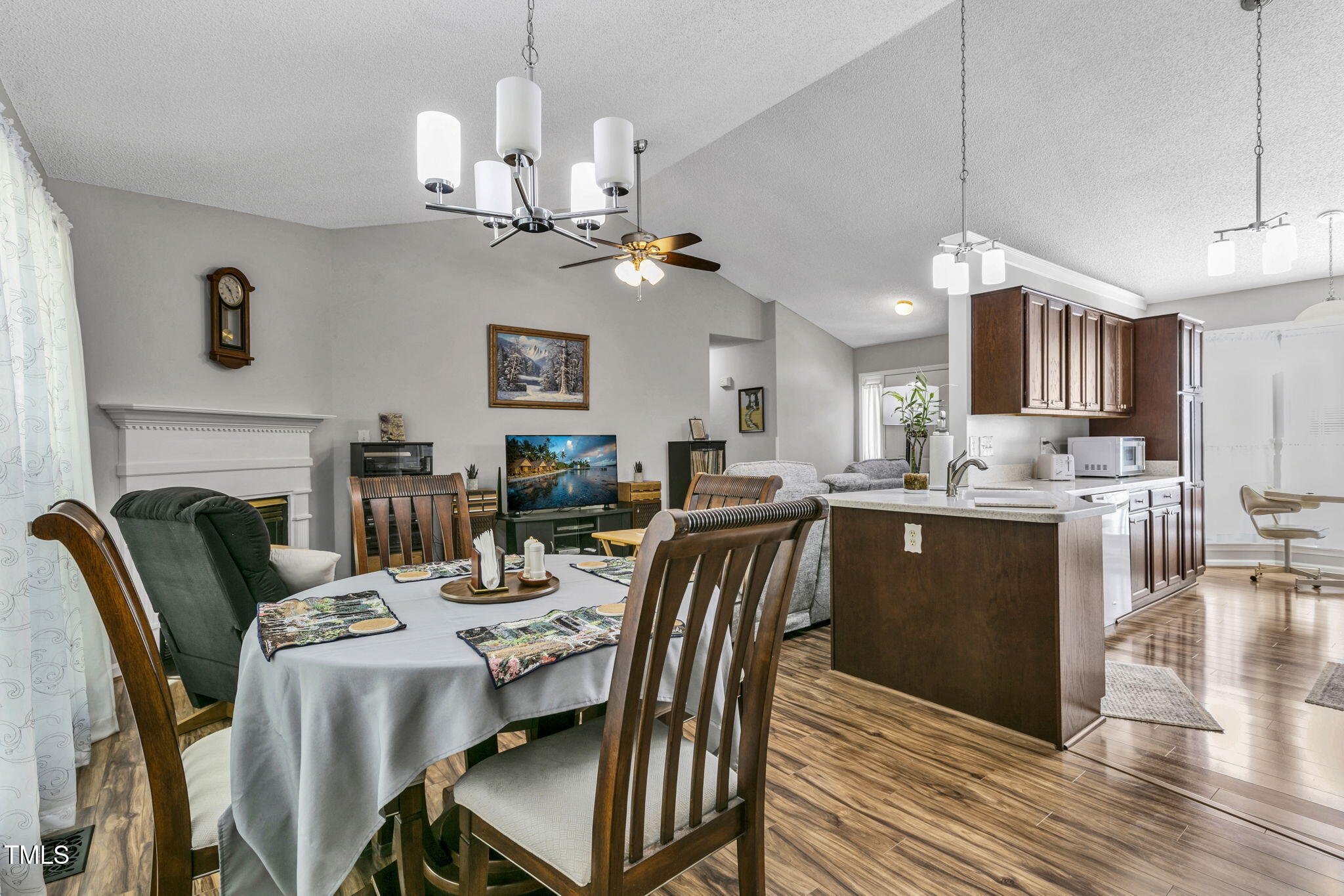 4317 Snow Goose Court Raleigh, NC 27616 - Photo 15 of 43 a view of a dining room with furniture a chandelier and wooden floor