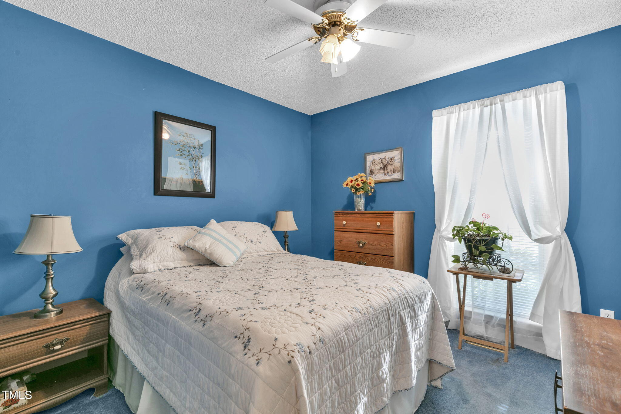 4317 Snow Goose Court Raleigh, NC 27616 - Photo 22 of 43 a bedroom with a bed and a chandelier