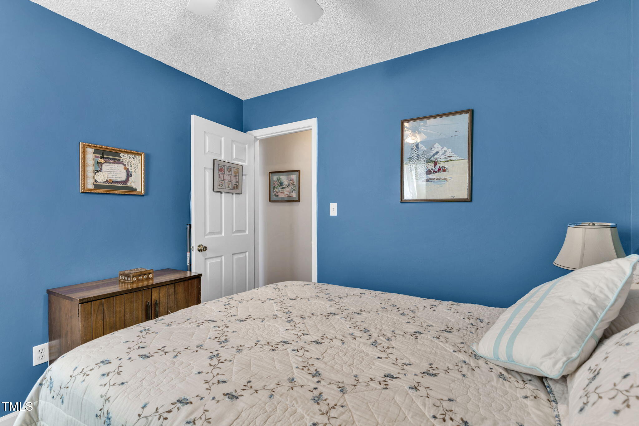 4317 Snow Goose Court Raleigh, NC 27616 - Photo 23 of 43 a bedroom with a bed and a wall painting