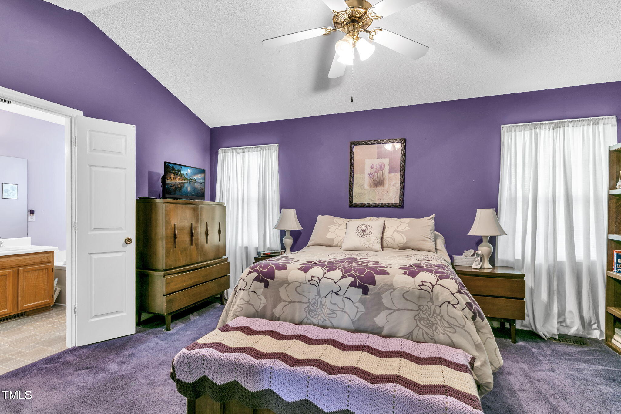4317 Snow Goose Court Raleigh, NC 27616 - Photo 25 of 43 a bedroom with a bed and a chandelier