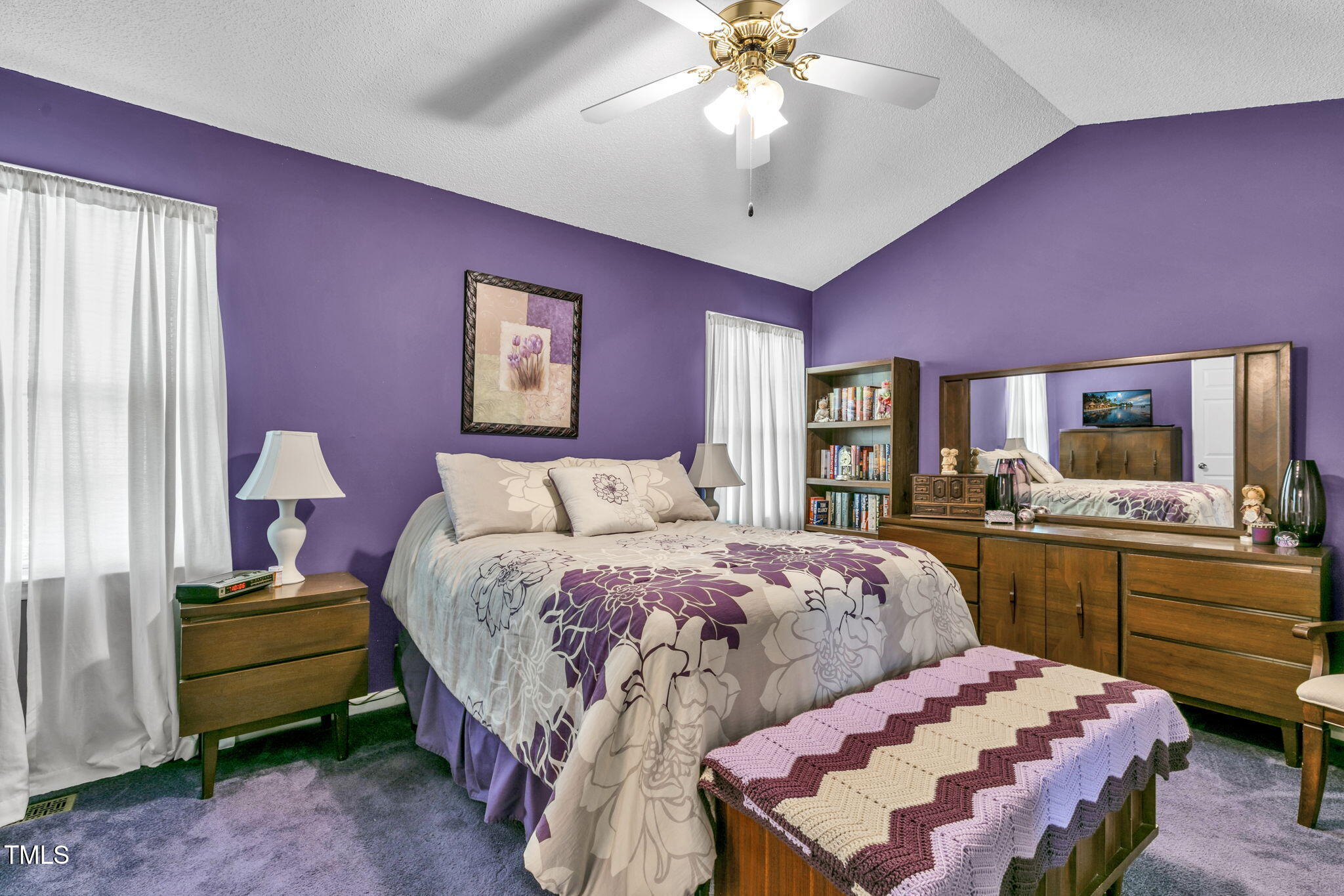 4317 Snow Goose Court Raleigh, NC 27616 - Photo 27 of 43 a bedroom with a bed and a chandelier