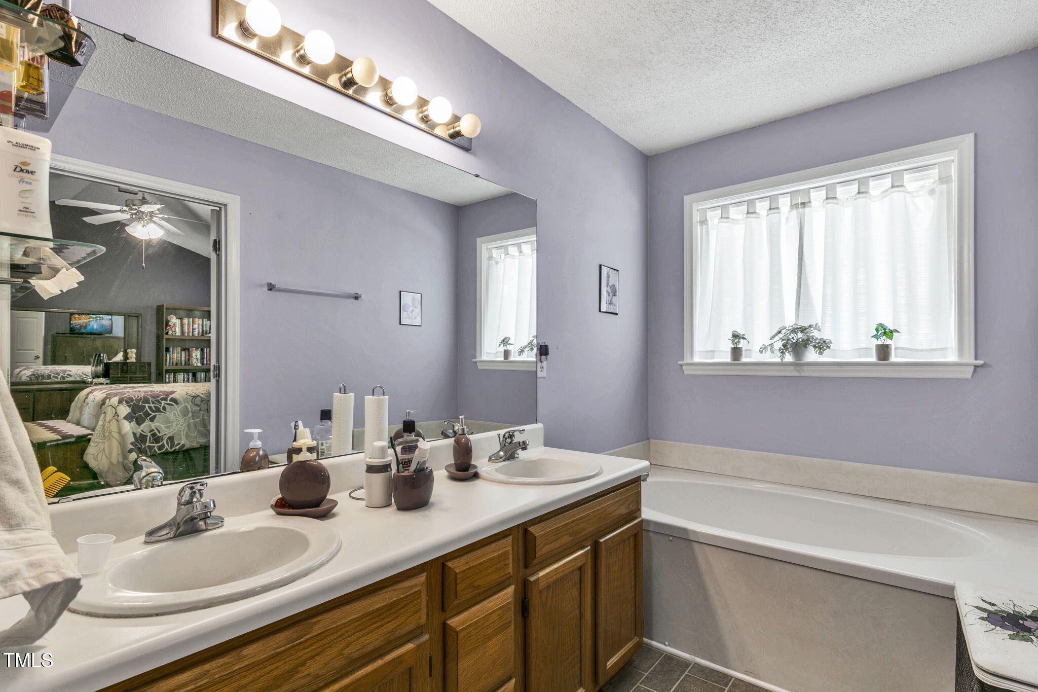 4317 Snow Goose Court Raleigh, NC 27616 - Photo 28 of 43 a bathroom with a sink double vanity granite and a mirror