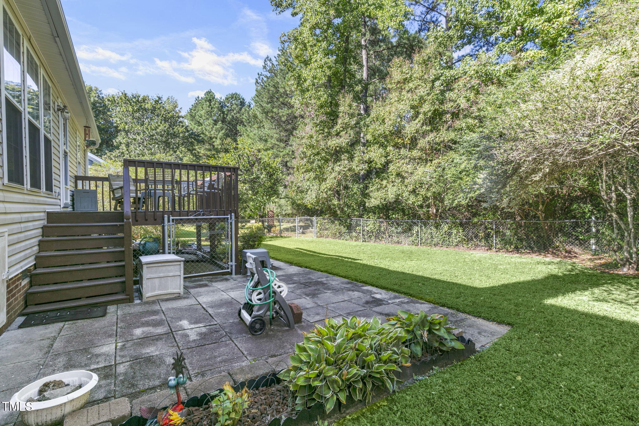 4317 Snow Goose Court Raleigh, NC 27616 - Photo 42 of 43 a view of a deck with a chair and floor to ceiling window