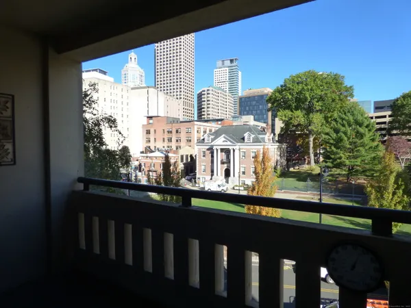 a view of a balcony with two chairs and a table
