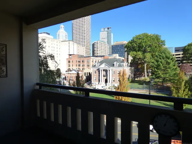 a view of a balcony with two chairs and a table