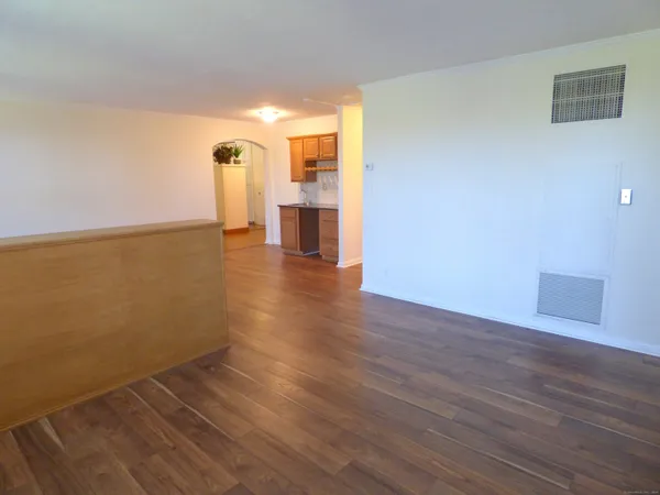 a view of a room with wooden floor