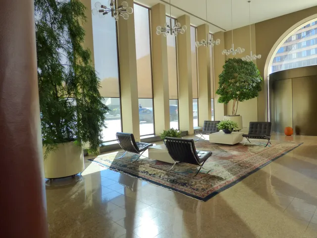 a living room with a large window and wooden floor