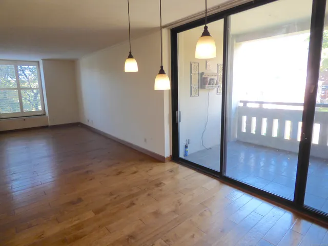 a view of a room with wooden floor and windows
