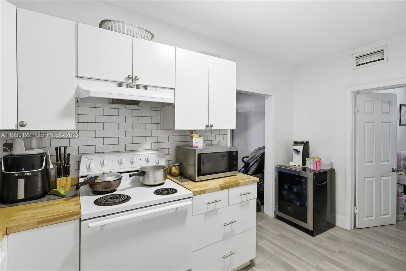 2142 Northwest 33rd Street Miami, FL 33142 - Photo 12 of 26 a kitchen with a stove and cabinets