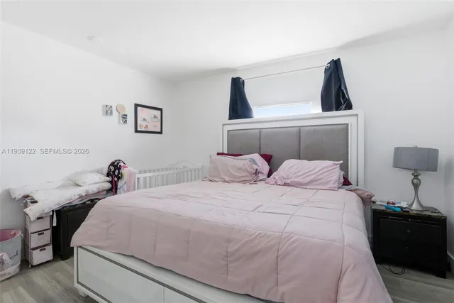 a bedroom with a bed and a lamp