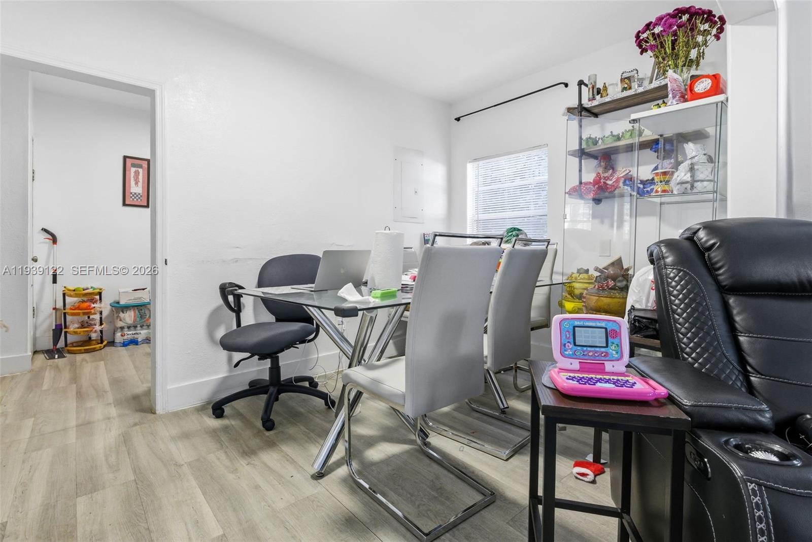 2142 Northwest 33rd Street Miami, FL 33142 - Photo 15 of 26 a workspace with furniture and a ceiling fan