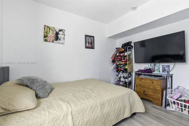 a bedroom with a bed and a flat screen tv