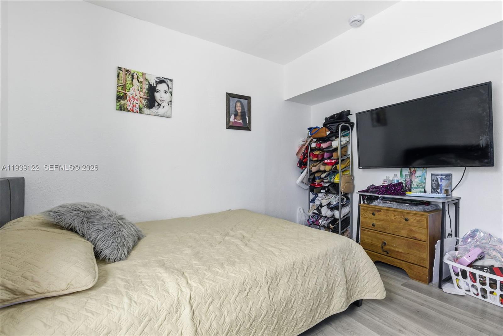 2142 Northwest 33rd Street Miami, FL 33142 - Photo 17 of 26 a bedroom with a bed and a flat screen tv