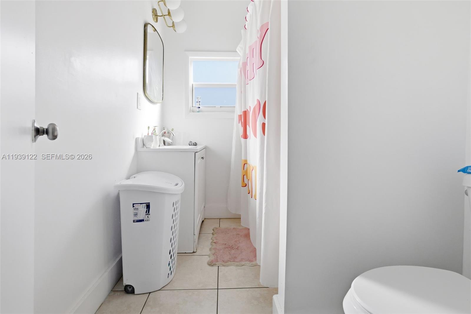 2142 Northwest 33rd Street Miami, FL 33142 - Photo 18 of 26 a bathroom with a sink toilet and mirror