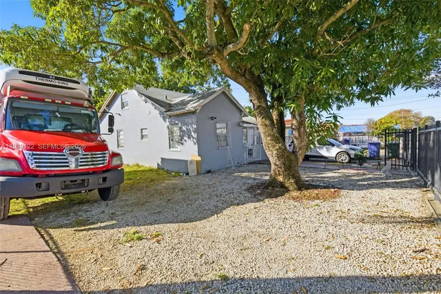 a backyard of a house with barbeque oven fire pit table and chairs