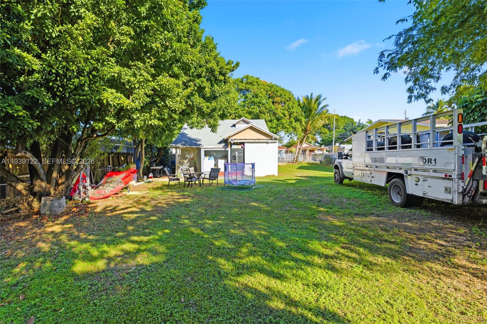 2142 Northwest 33rd Street Miami, FL 33142 - Photo 7 of 26 a front view of a house with a garden