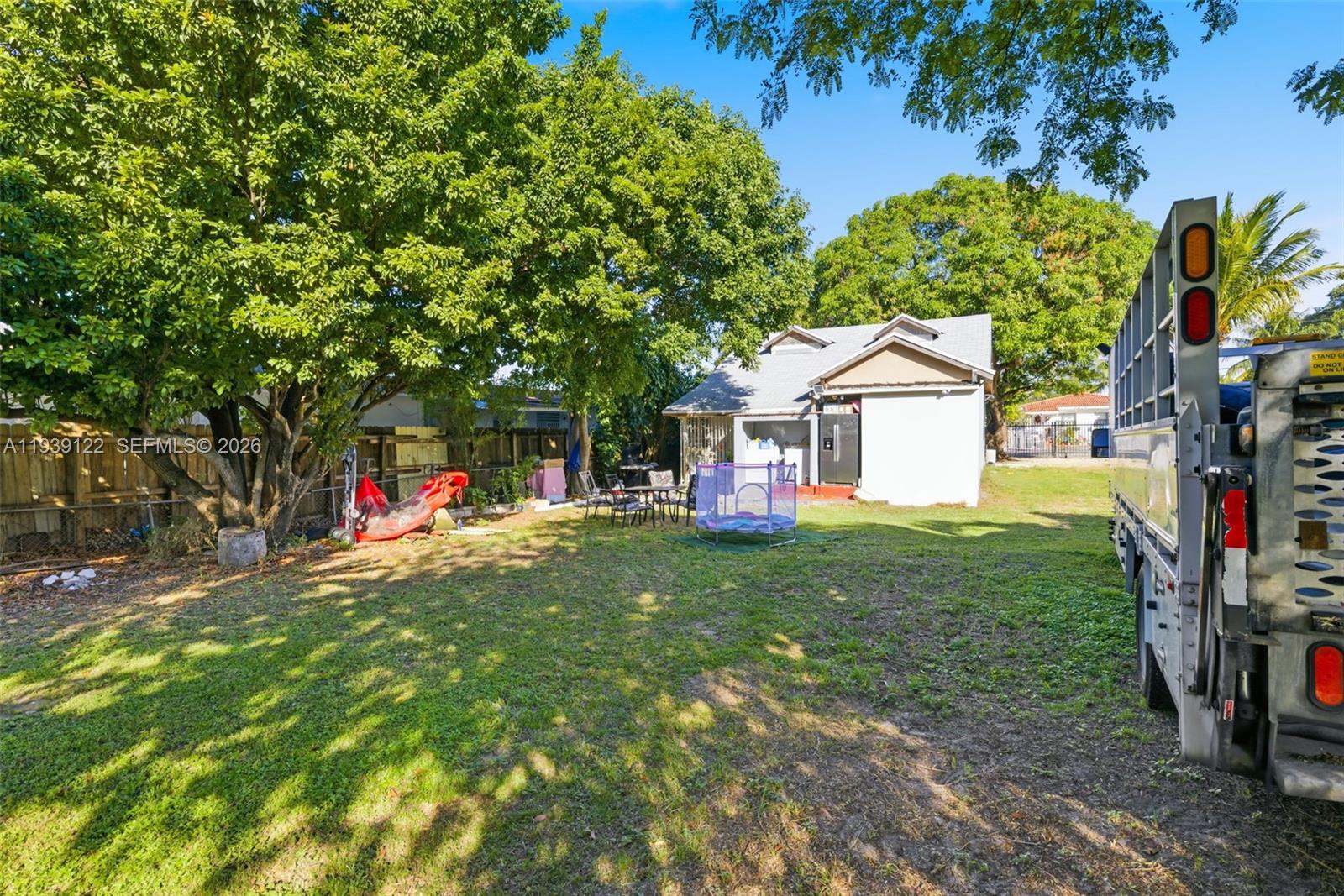 2142 Northwest 33rd Street Miami, FL 33142 - Photo 8 of 26 a view of a house with a yard