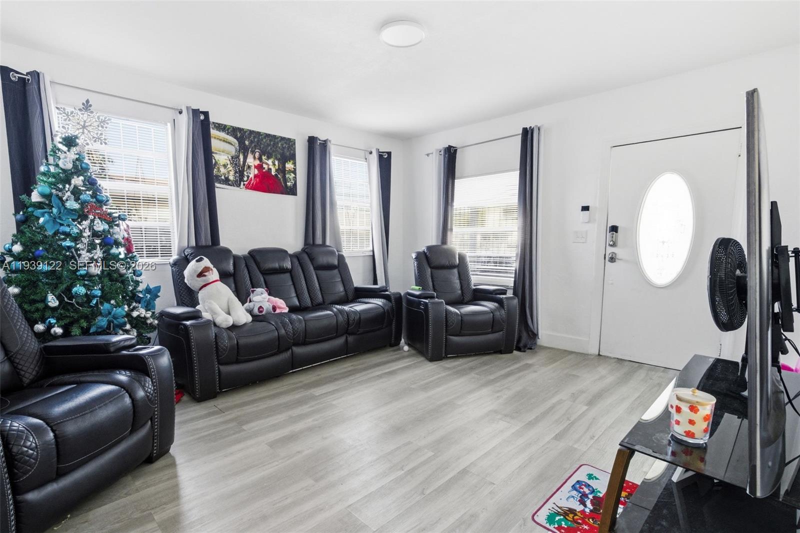 2142 Northwest 33rd Street Miami, FL 33142 - Photo 9 of 26 a living room with furniture and a large window