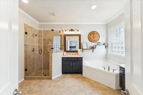 a spacious bedroom with a bed and wooden floor