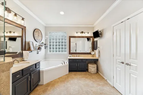 a large bathroom with a large tub shower sink and vanity