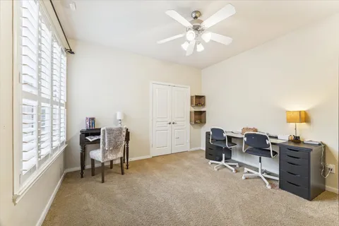 a spacious bathroom with a tub sink and mirror