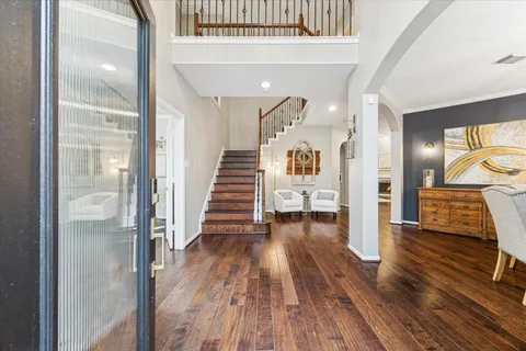 a view of a hallway view with wooden floor and staircase