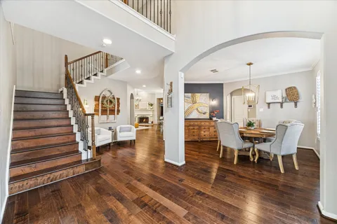 a view of a dining room with furniture and wooden floor