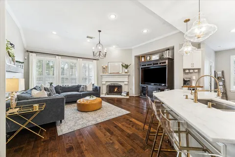 a living room with fireplace furniture and a flat screen tv