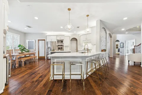 a large kitchen with a table and chairs