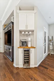 a kitchen with granite countertop a refrigerator and a stove top oven