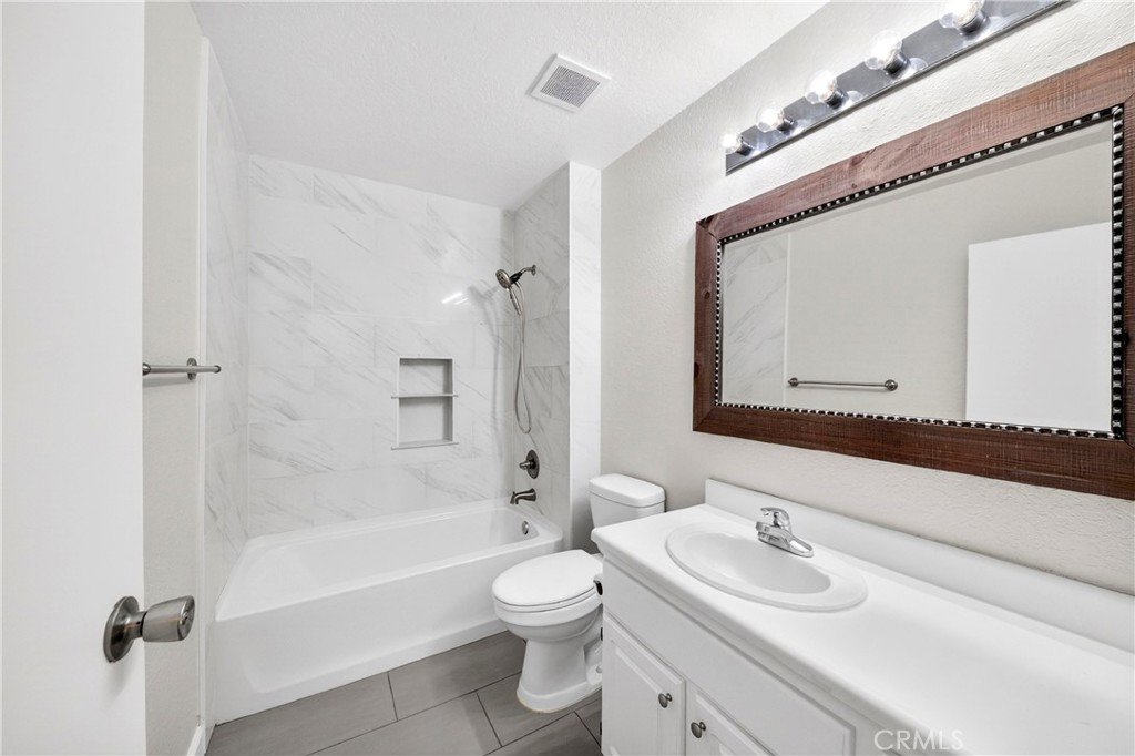 10151 Arrow Route, Unit 26 Rancho Cucamonga, CA 91730 - Photo 13 of 35 a bathroom with a sink a toilet and shower