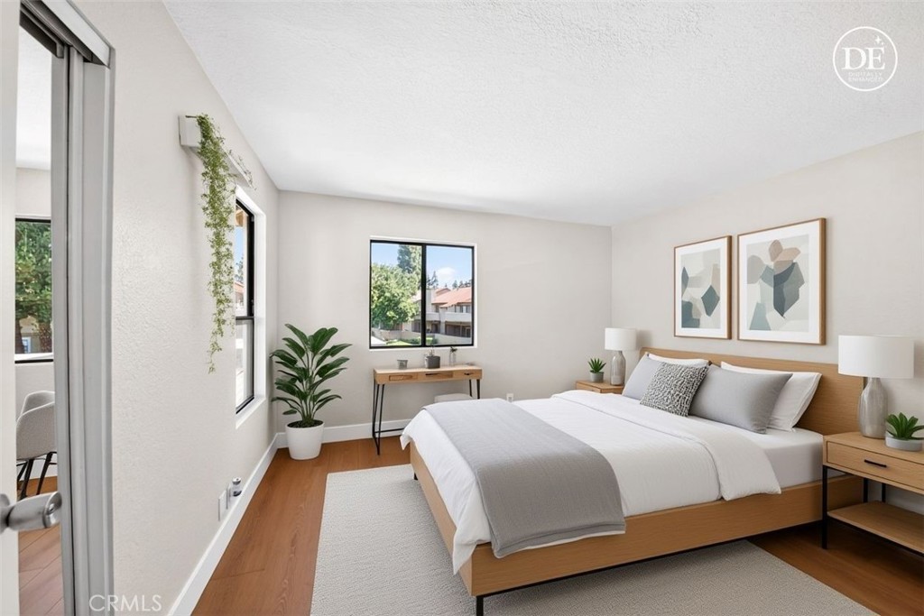 10151 Arrow Route, Unit 26 Rancho Cucamonga, CA 91730 - Photo 14 of 35 a bedroom with a large bed and a potted plant