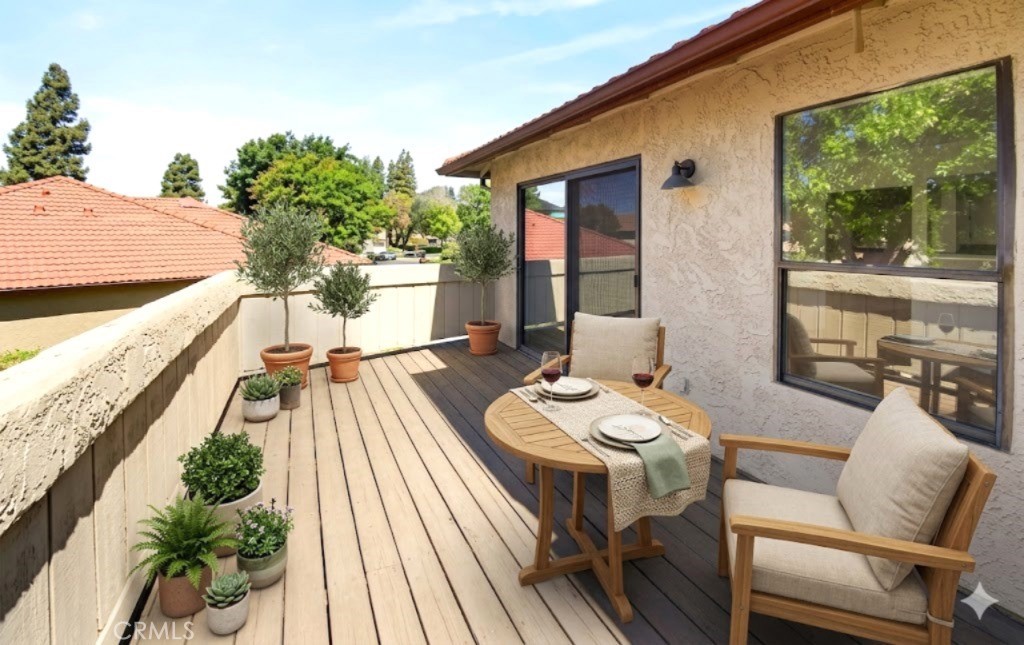 10151 Arrow Route, Unit 26 Rancho Cucamonga, CA 91730 - Photo 18 of 35 a balcony with furniture and wooden floor