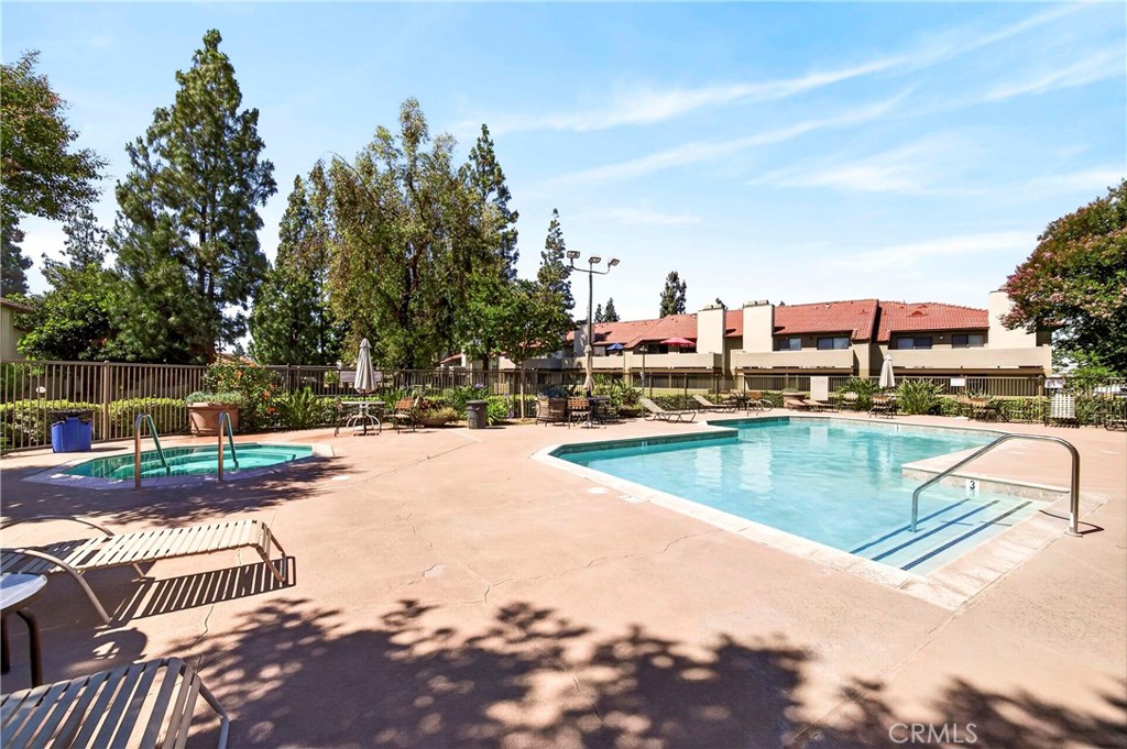 10151 Arrow Route, Unit 26 Rancho Cucamonga, CA 91730 - Photo 24 of 35 a view of a swimming pool with a patio and a yard