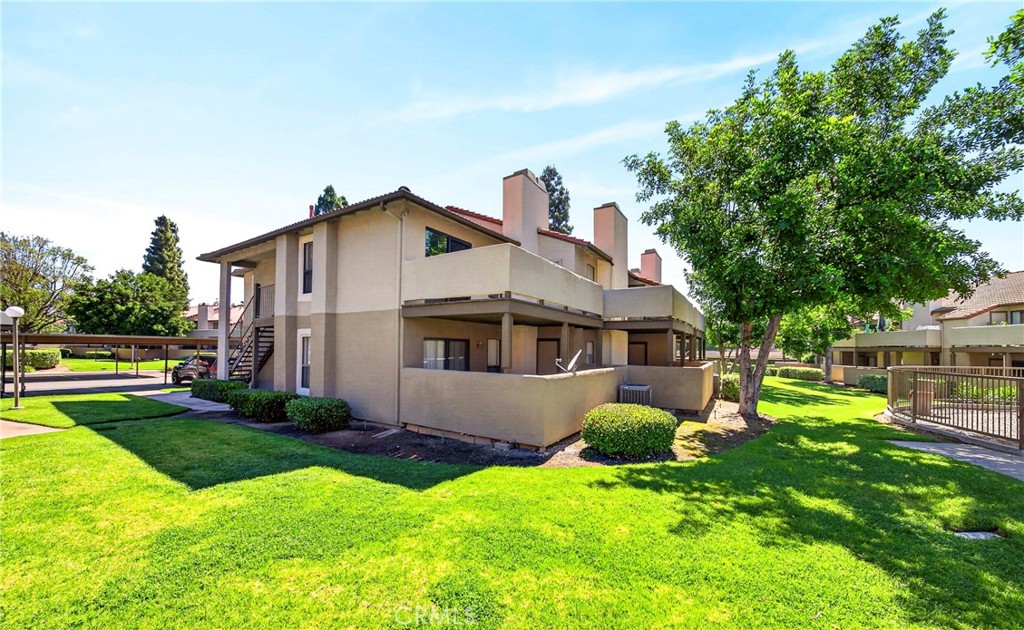 10151 Arrow Route, Unit 26 Rancho Cucamonga, CA 91730 - Photo 31 of 35 a front view of house with yard and green space