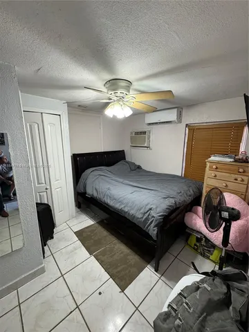 a bedroom with a bed and a mirror