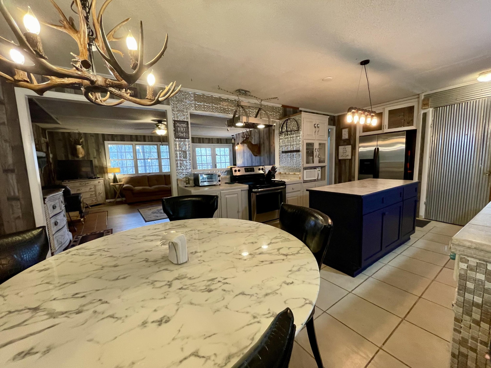 1522 Turkey Creek Road Tellico Plains, TN 37385 - Photo 7 of 34 a kitchen with stainless steel appliances kitchen island granite countertop a stove top oven and cabinets
