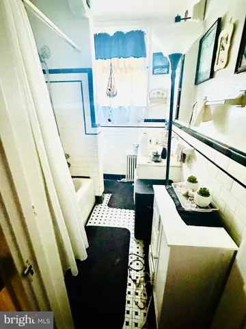 a dining room with furniture and a floor to ceiling window