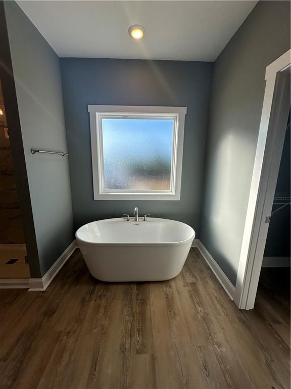 5207 Lee Road Salem, AL 36874 - Photo 10 of 23 Bathroom with a soaking tub, dark wood-type flooring, and walk in shower