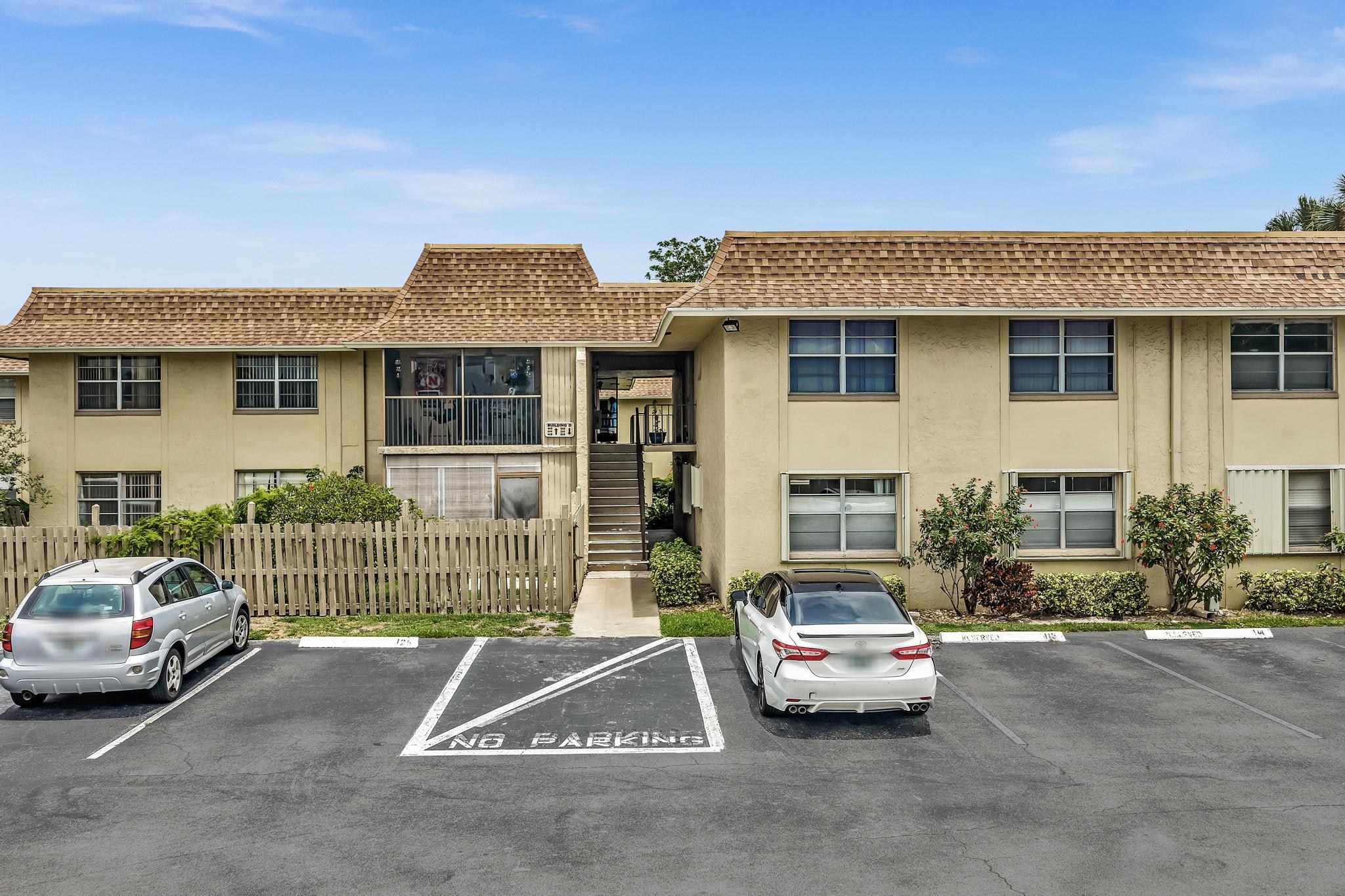 1291 Northwest 13th Street, Unit 445D Boca Raton, FL 33486 - Photo 43 of 50 a car parked in front of a house