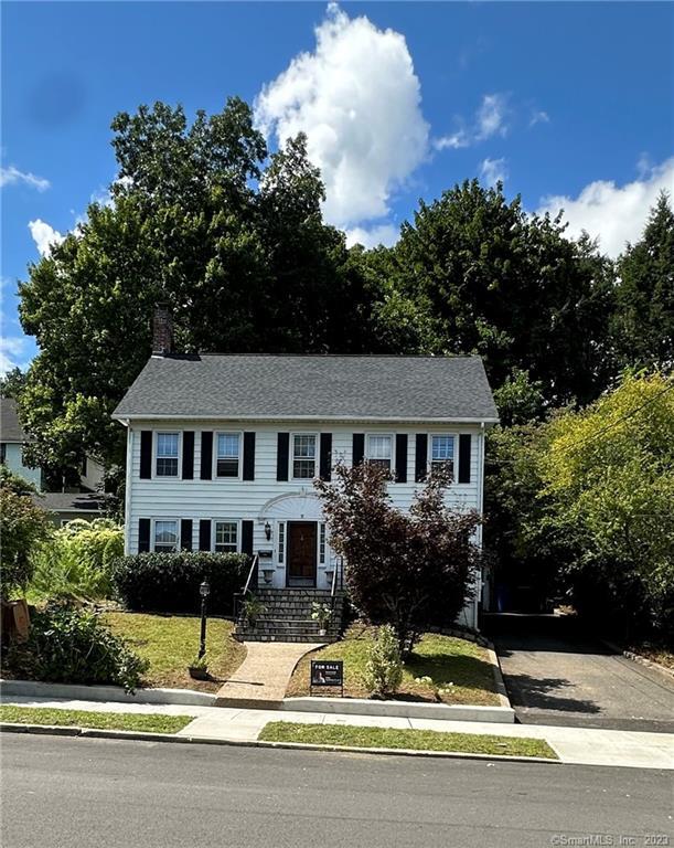 a view of a house and a yard and tree s