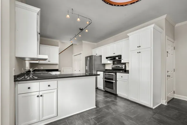 a bathroom with a sink a toilet a mirror and shower