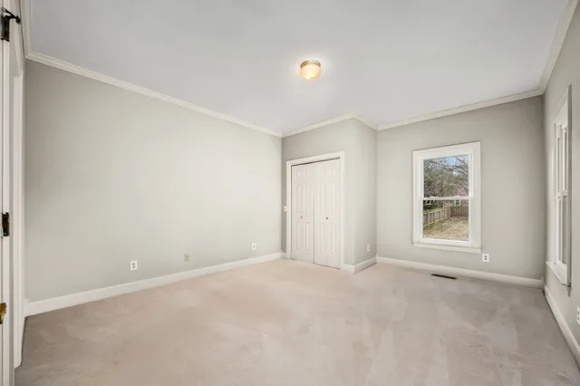 a view of an empty room with a ceiling fan