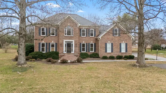 a view of a hallway with wooden floor and stairs