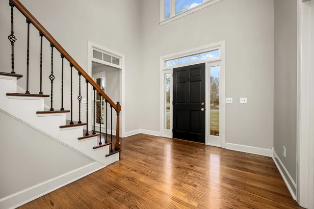 a view of an empty room with a fireplace and a window