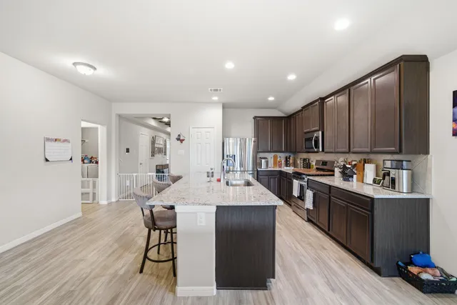 a large kitchen with lots of counter space a sink and appliances